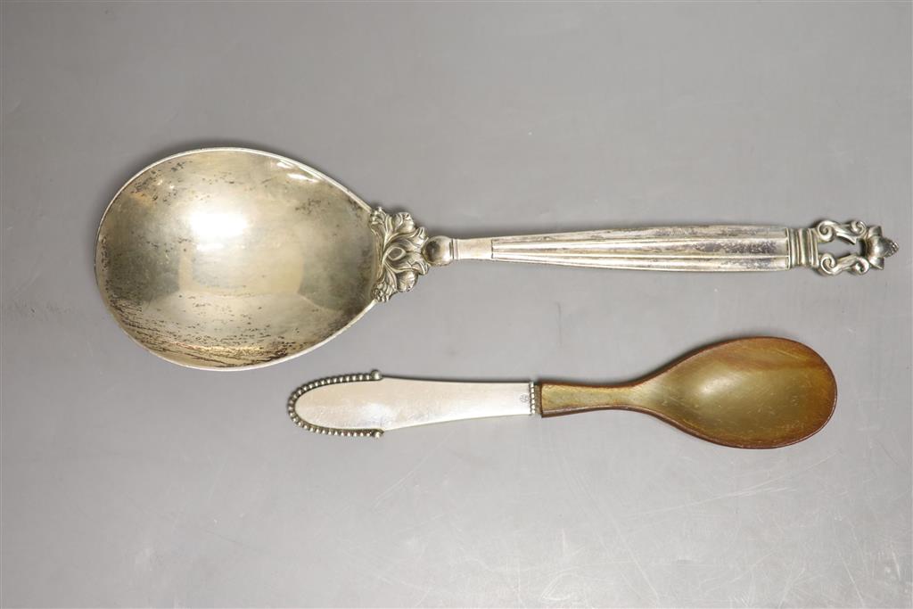 A 1920s Georg Jensen sterling Acorn pattern serving spoon, 23cm and one other Jensen spoon with horn bowl, gross 124 grams.